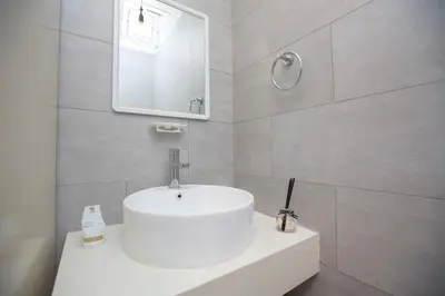 a bathroom with a white sink and a mirror at Arte Mont Kiara by MY TRIP & MY STAY in Kuala Lumpur