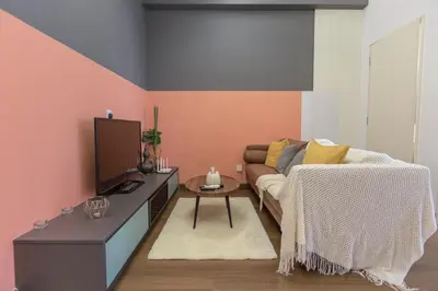 a living room with a couch and a tv at Arte Mont Kiara by MY TRIP & MY STAY in Kuala Lumpur