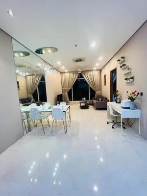 a large living room with white floors and tables and chairs at Soho Suites KLCC by Comfort Suites Kuala Lumpur in Kuala Lumpur