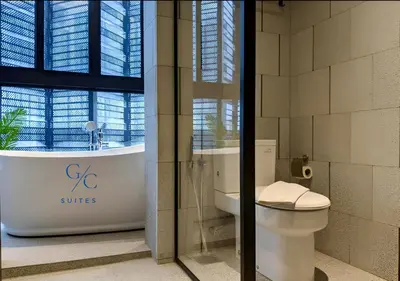 a bathroom with a toilet and a tub and a window at Scarletz KLCC luxury suites by GC-Suites in Kuala Lumpur