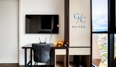 a black chair sitting at a table in a room at Scarletz KLCC luxury suites by GC-Suites in Kuala Lumpur