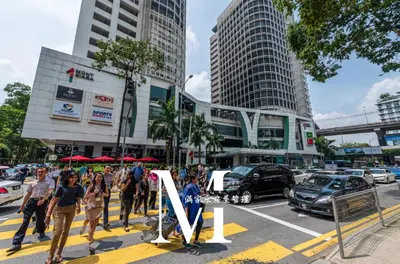 a group of people walking on a city street at Arcoris Mont Kiara 2# Sunway 163# 2-Bedroom with balcony 2-4Pax in Kuala Lumpur