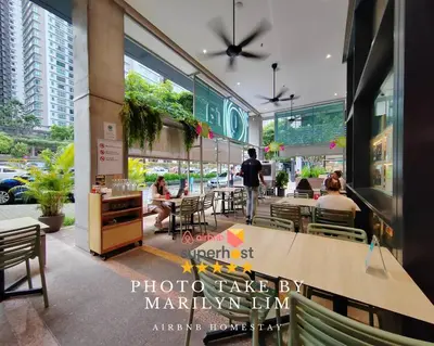 a restaurant with people sitting at tables in a building at Arcoris Mont Kiara 19#Main Street# Walking Distance 1MK# 1BR 1-3Pax in Kuala Lumpur