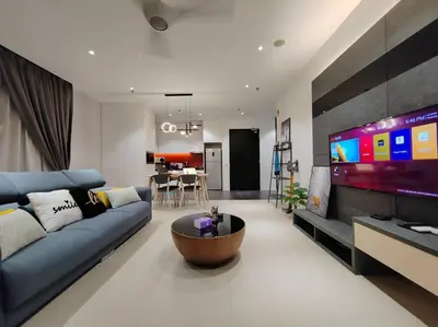 a living room with a blue couch and a large tv at Arcoris Mont Kiara 19#Main Street# Walking Distance 1MK# 1BR 1-3Pax in Kuala Lumpur