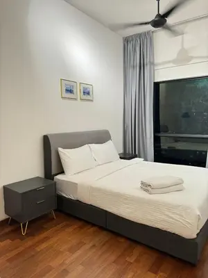 a bedroom with a large bed with white sheets and a window at REIZZ RESIDENCE BY BERJAYA in Kuala Lumpur