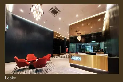 a lobby with red chairs and a reception desk at Stunning Pool & the City - 1 mrt stop to TRX in Kuala Lumpur