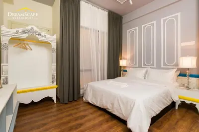 a bedroom with a large white bed and a window at VALENTINA SUITES @ ARTE MONT KIARA in Kuala Lumpur