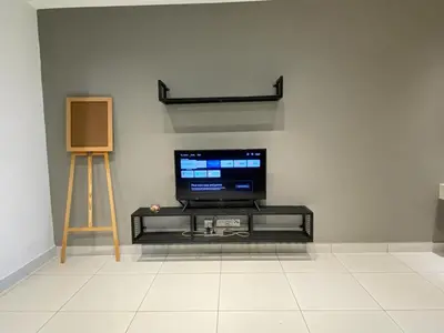 a flat screen tv sitting on a stand in a room at VALENTINA SUITES @ ARTE MONT KIARA in Kuala Lumpur