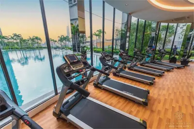 a row of treadmills in a gym next to a pool at Trion One Suites Kuala Lumpur by Five Senses in Kuala Lumpur