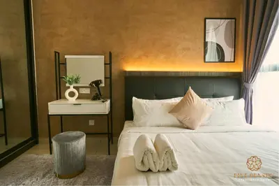 a bedroom with a bed with two towels on it at Trion One Suites Kuala Lumpur by Five Senses in Kuala Lumpur