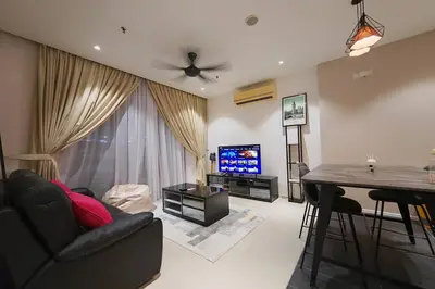 a living room with a couch and a table and a television at Mont Kiara Cozy 2 #2Bedroom with Balcony #Arcoris in Kuala Lumpur