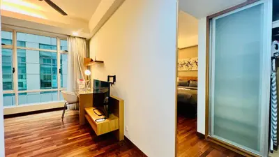 a room with a desk and a bed and a window at Lot163 By ZenGlo in Kuala Lumpur