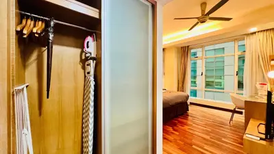 a living room with a ceiling fan and a sliding door at Lot163 By ZenGlo in Kuala Lumpur