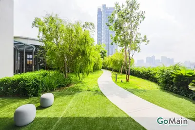 a walkway in a park next to a building at [4 Pax] Trion KL // Near Pavillion KL KLCC TRX in Kuala Lumpur