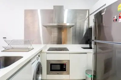 a kitchen with a stove and a refrigerator at M City Residence by Airhost in Kuala Lumpur