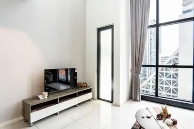 a living room with a tv and a large window at M City Residence by Airhost in Kuala Lumpur