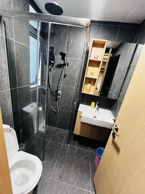 a bathroom with a shower and a toilet and a sink at Voyage Bedroom, The Luxe Colony in Kuala Lumpur
