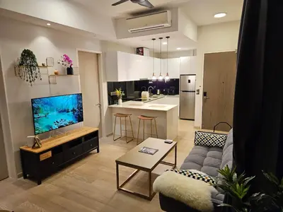 a living room with a couch and a kitchen at Star Residence 2br Unit Floor 46 in Kuala Lumpur
