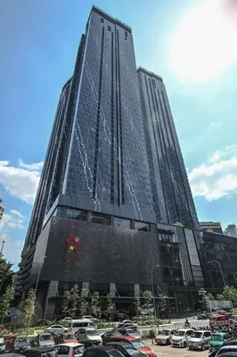 a tall building with cars parked in a parking lot at Star Residence 2br Unit Floor 46 in Kuala Lumpur