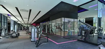 a gym with exercise equipment in front of a building at Star Residence 2br Unit Floor 46 in Kuala Lumpur