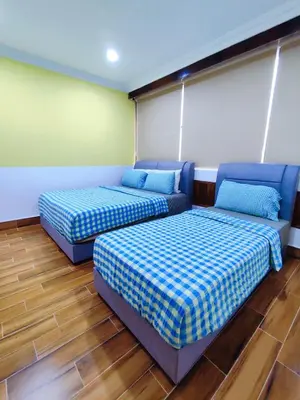 two beds in a room with blue at Nice Stay 16pax at Wisma Cosway Pavilion KLCC Bukit Bintang in Kuala Lumpur