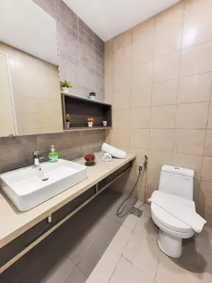 a bathroom with a toilet and a sink and a mirror at Robertson Residences in Kuala Lumpur