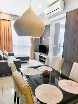 a living room with a table and chairs at Robertson Residences in Kuala Lumpur