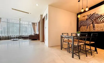 a dining room with a painting of zebras on the wall at Vortex KLCC by apartx in Kuala Lumpur
