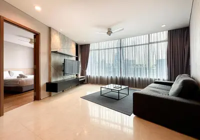 a living room with a couch and a large window at Vortex KLCC by apartx in Kuala Lumpur