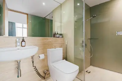 a bathroom with a toilet and a sink and a shower at Vortex KLCC by apartx in Kuala Lumpur