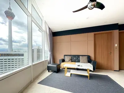 a living room with a couch and a table at Vortex KLCC by apartx in Kuala Lumpur
