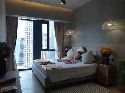 a bedroom with a large bed with large windows at KLCC Star Suites by BBA in Kuala Lumpur