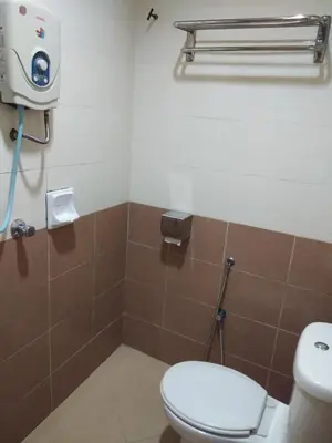 a bathroom with a toilet and a camera on the wall at KL CITY LODGE in Kuala Lumpur