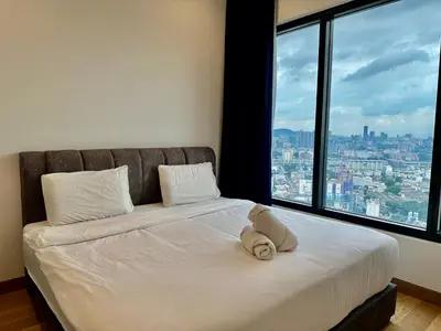 a bed in a room with a large window at Smart Home at Lucentia Residence BBCC Lalaport in Kuala Lumpur