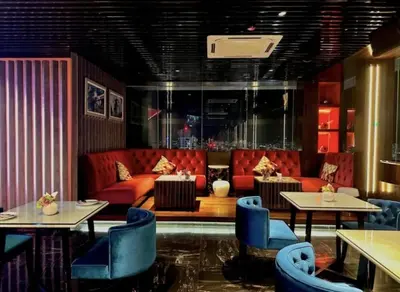 a restaurant with red couches and blue chairs at The Platinum KLCC By Luxe Suites in Kuala Lumpur