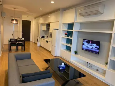 a living room with a couch and a tv on a wall at The Platinum KLCC By Luxe Suites in Kuala Lumpur