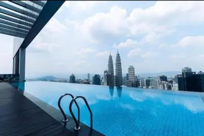 a swimming pool with a view of a city at The Platinum KLCC By Luxe Suites in Kuala Lumpur
