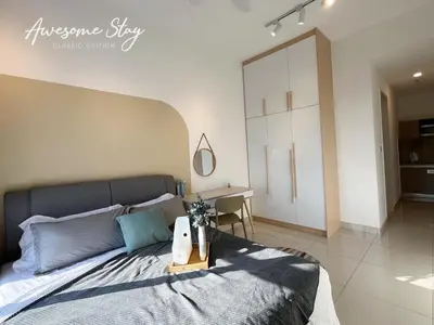 a bedroom with a large bed and a desk at Trion @ KL By The Relaxstay in Kuala Lumpur