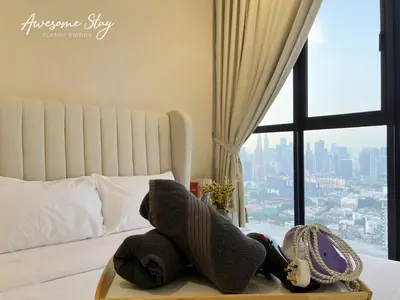 a stuffed animal sitting on a bed with a window at Trion @ KL By The Relaxstay in Kuala Lumpur