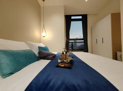 a bedroom with a large bed with a blue blanket at Arcoris Mont Kiara 7# Main Street #Walking 1MK# 163 Retails# 2 BR Balcony 2-4Pax in Kuala Lumpur