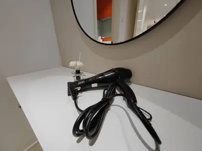 a black hair dryer on a counter with a mirror at Arcoris Mont Kiara 7# Main Street #Walking 1MK# 163 Retails# 2 BR Balcony 2-4Pax in Kuala Lumpur