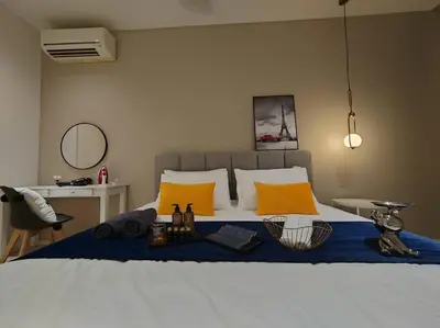 a bedroom with a large bed with yellow pillows at Arcoris Mont Kiara 7# Main Street #Walking 1MK# 163 Retails# 2 BR Balcony 2-4Pax in Kuala Lumpur