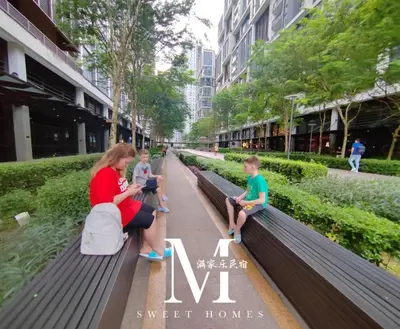 a woman and two children sitting on a park bench at Arcoris Mont Kiara 7# Main Street #Walking 1MK# 163 Retails# 2 BR Balcony 2-4Pax in Kuala Lumpur