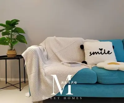 a blue couch with a blanket and a pillow on it at Arcoris Mont Kiara 19# Deluxe 1 Bedroom With Balcony KL #1-3Pax in Kuala Lumpur