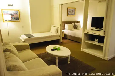 a living room with a couch and a tv at The Suites at Times Square KL by Robinsons in Kuala Lumpur
