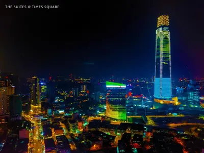 a city skyline at night with a tall building at The Suites at Times Square KL by Robinsons in Kuala Lumpur