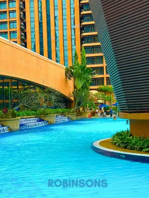 a large swimming pool in a city with tall buildings at The Suites at Times Square KL by Robinsons in Kuala Lumpur