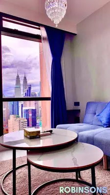 a living room with a couch and a table and a window at The Suites at Times Square KL by Robinsons in Kuala Lumpur