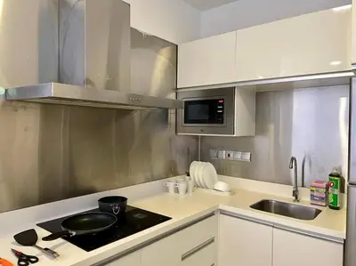 a small kitchen with a stove and a sink at [M City Duplex Studio] Stunning High Floor View! in Kuala Lumpur