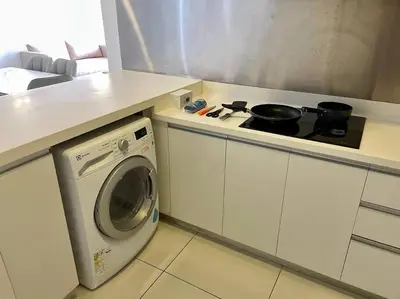 a kitchen with a stove and a washing machine at [M City Duplex Studio] Stunning High Floor View! in Kuala Lumpur